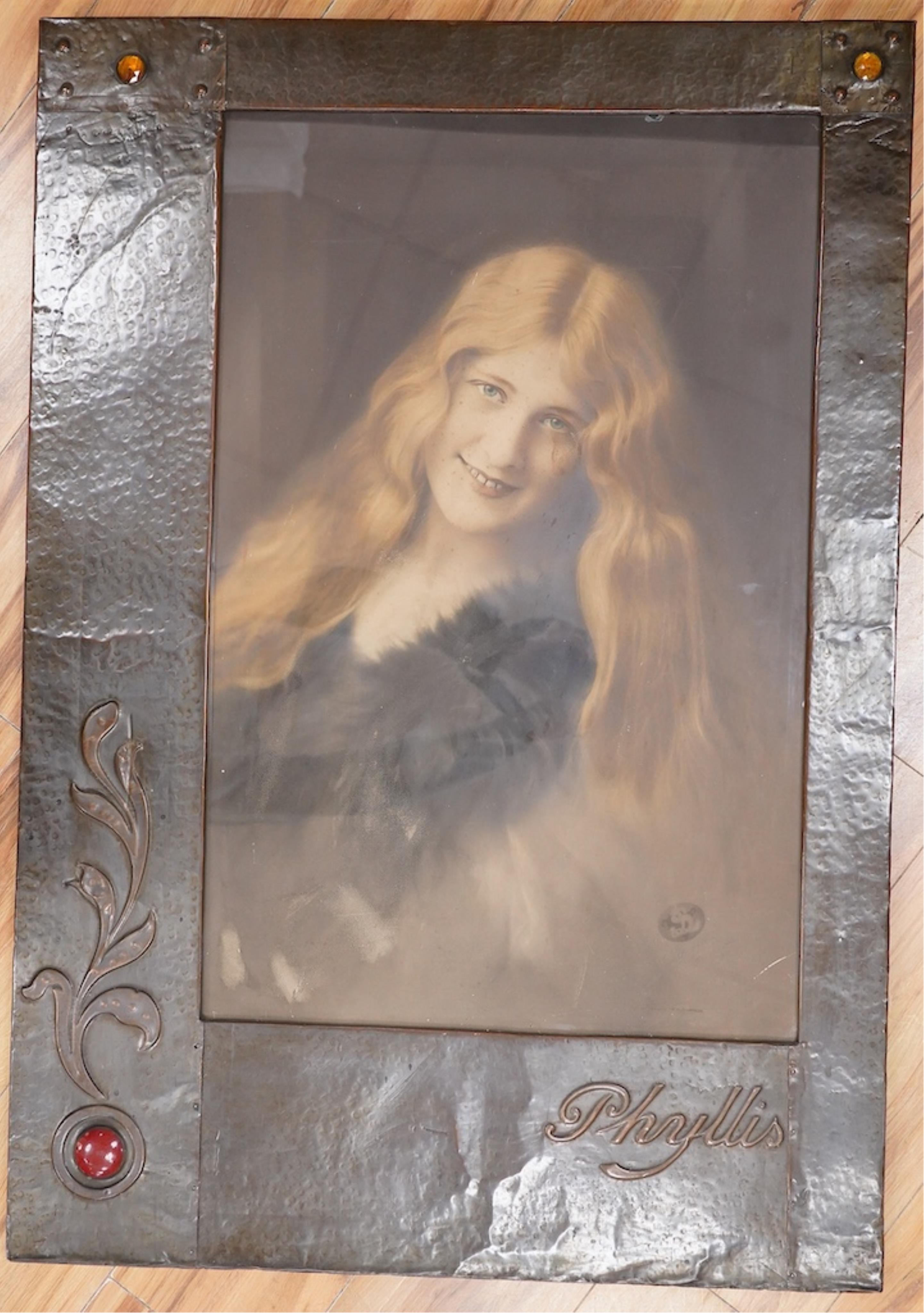 A large Arts & Crafts planished copper frame housing a photograph of Phyllis Dare, an early 20th century actress from Hove, taken by Louis Langfier, overall 100 x 70cm. Condition - fair to good